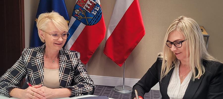 Członkini Zarządu Województwa Anna Bańkowska (z prawej) oraz prezydent Kołobrzegu Anna Mieczkowska podpisały umowę gwarantująca unijne wsparcie na przebudowę ulicy Spacerowej w Kołobrzegu.